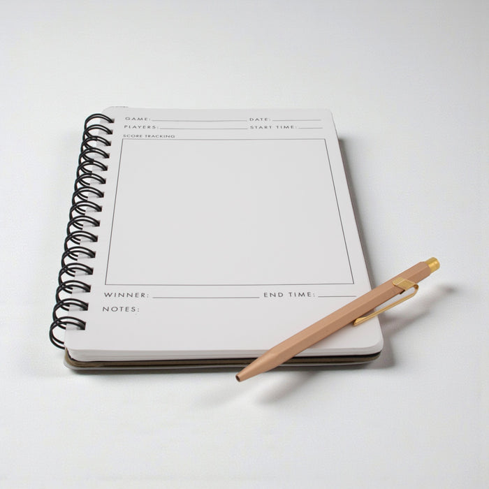 Game Night Journal opened to a score page with a pen on a white background