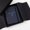 Blue notebook titled 'Mix Manual' with a black cover on a white background
